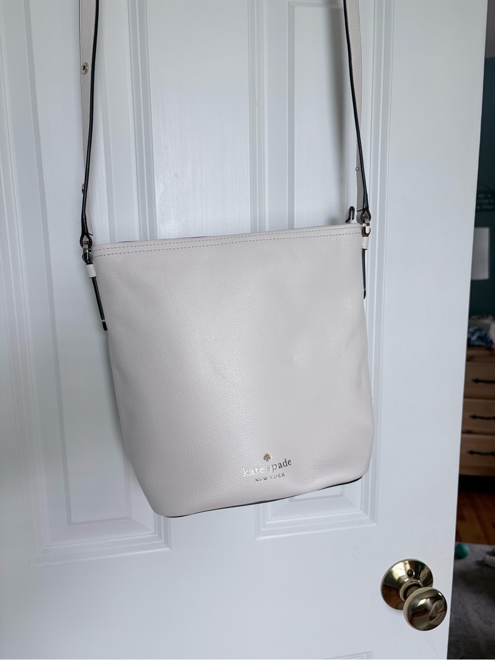 kate spade cream pebbled leather crossbody with black-trim strap